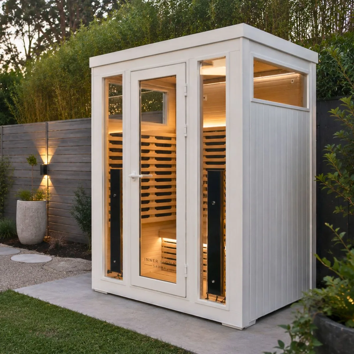 White Inner Light Bella Deluxe 3 outdoor infrared sauna in a garden