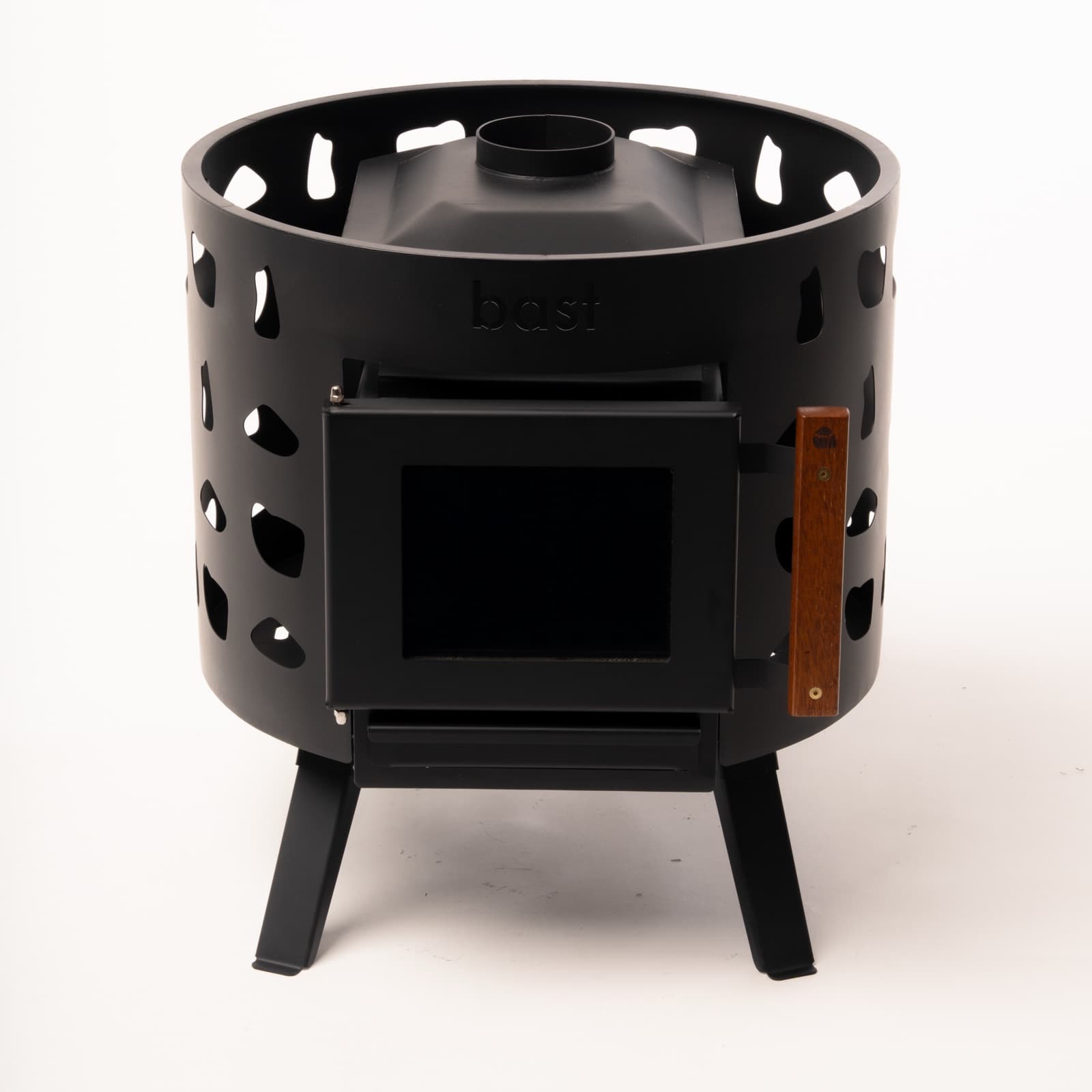 Bast Malm wood-fired sauna stove with a surrounding stone basket and glass firebox door
